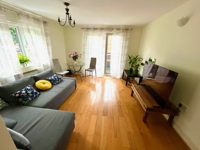 Newly renovated living room with corner sofa and hardwood floor