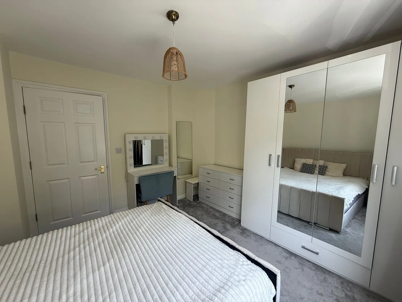 Master bedroom with king bed and mirrored wardrobes